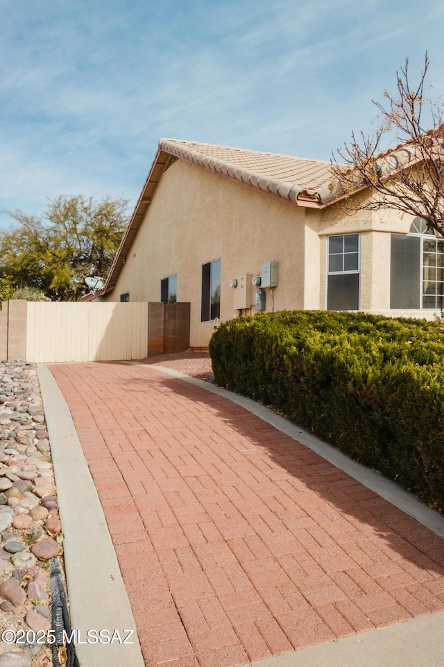 1524 W Sunridge Dr, Tucson, AZ 85704 - view of side of property with fence and stucco siding