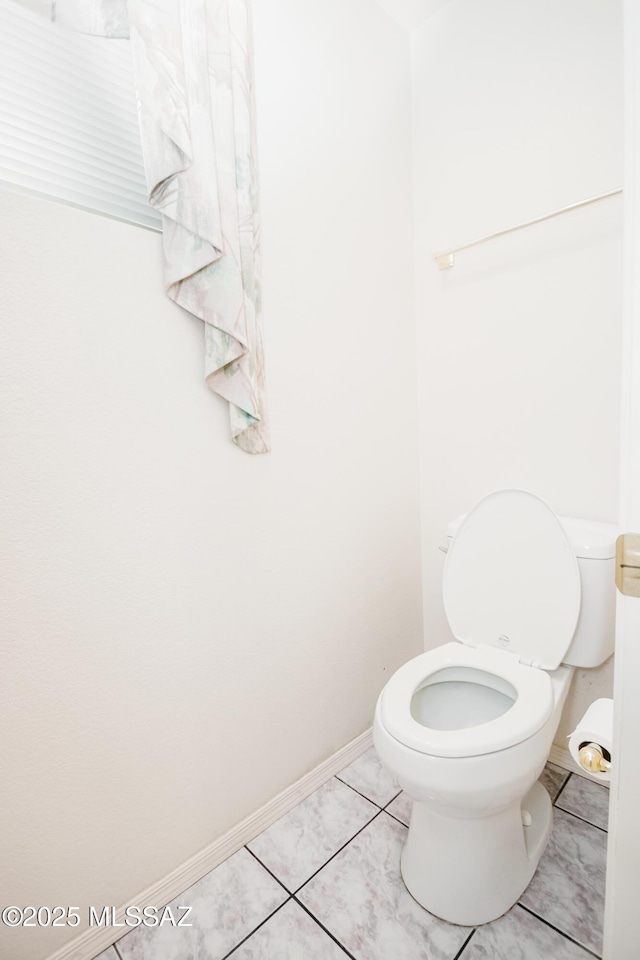 bathroom with tile patterned flooring and toilet