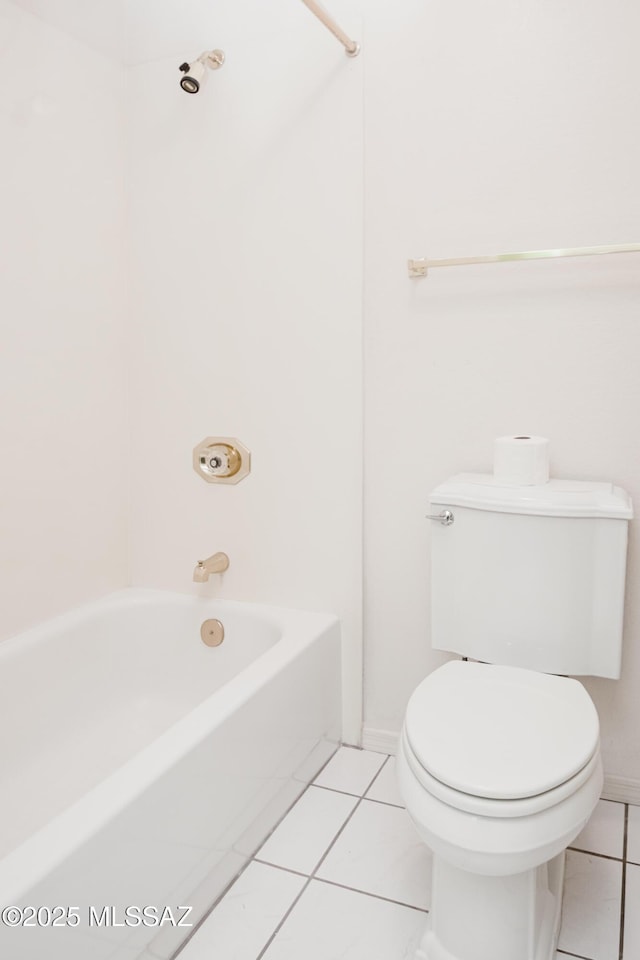 bathroom featuring bathing tub / shower combination, tile patterned floors, and toilet