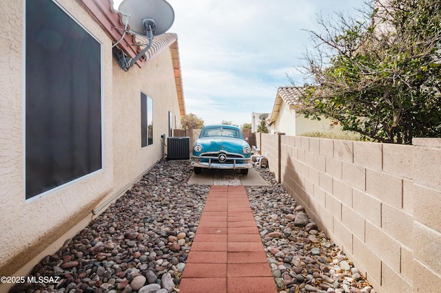 view of property exterior with central AC