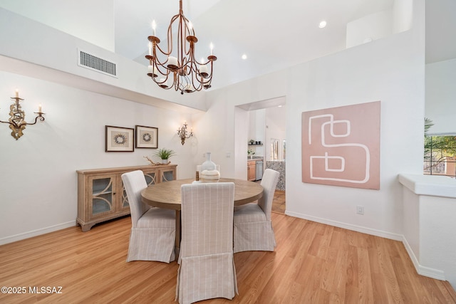 dining area featuring a notable chandelier, visible vents, light wood-style flooring, and baseboards