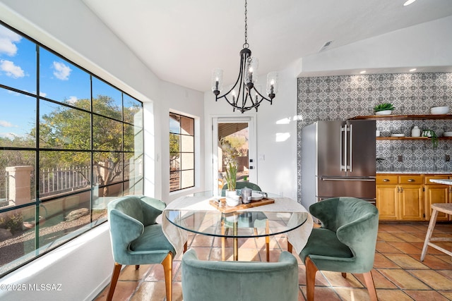 dining space with recessed lighting and a chandelier