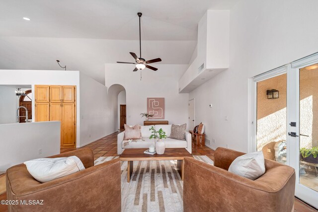 bedroom with hardwood / wood-style flooring, a towering ceiling, access to exterior, and ceiling fan