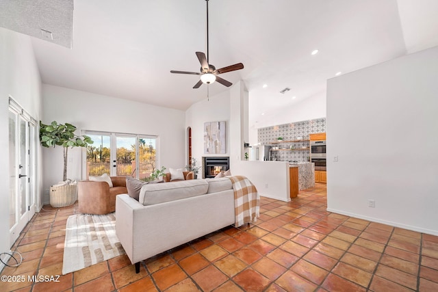 living area featuring visible vents, high vaulted ceiling, recessed lighting, ceiling fan, and a glass covered fireplace