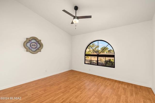 unfurnished room with baseboards, light wood-style floors, lofted ceiling, and ceiling fan