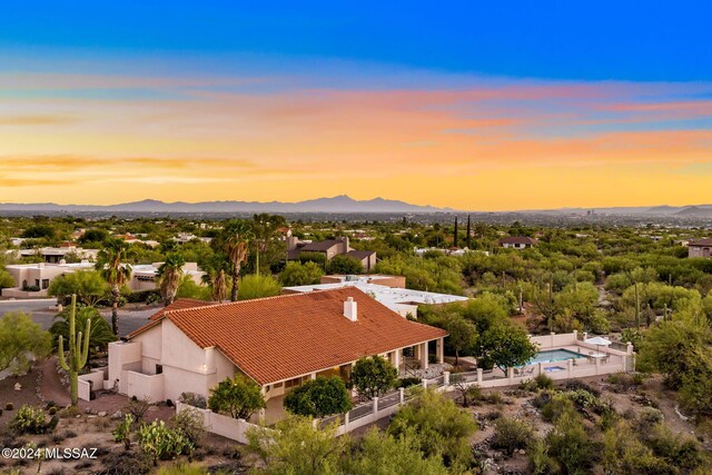 aerial view at dusk featuring a mountain view