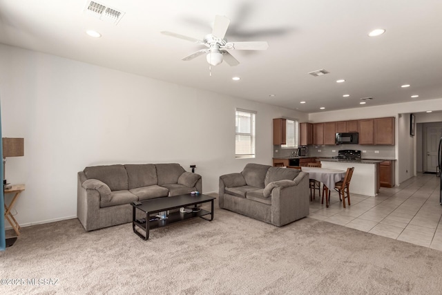 tiled living room featuring ceiling fan