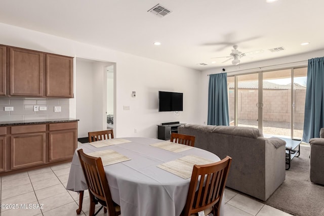 tiled dining area with ceiling fan