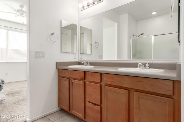 bathroom featuring tile patterned flooring, vanity, a shower with door, and ceiling fan