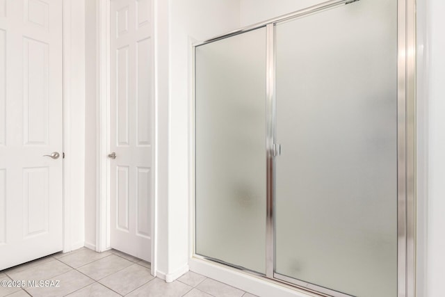 bathroom with tile patterned floors and walk in shower