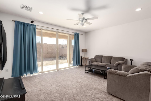 living room featuring carpet floors and ceiling fan