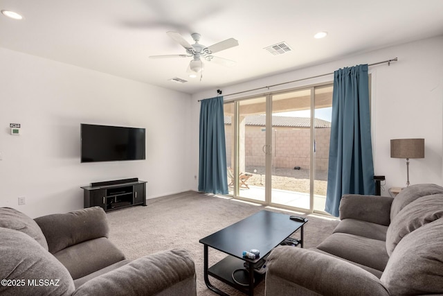 living room with ceiling fan and carpet