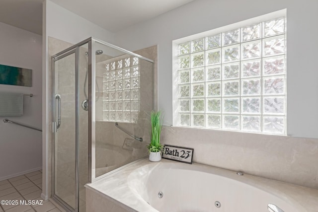 full bathroom featuring tile patterned floors, a tub with jets, and a stall shower