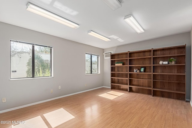 spare room featuring light wood-style flooring and baseboards