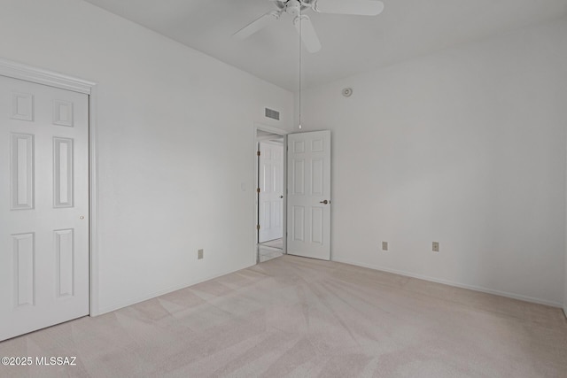 spare room featuring light carpet, baseboards, visible vents, and ceiling fan