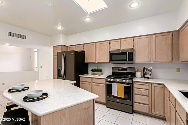 kitchen featuring visible vents, light brown cabinetry, a center island, recessed lighting, and appliances with stainless steel finishes