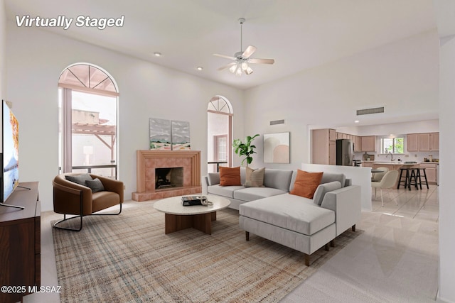 living room featuring visible vents, recessed lighting, a tile fireplace, and a ceiling fan