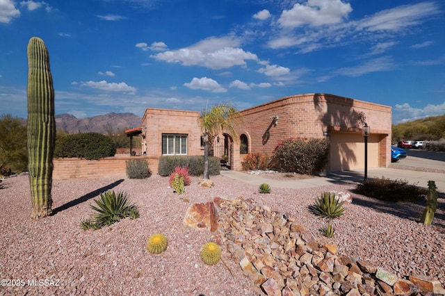 view of front of house with a garage and a mountain view