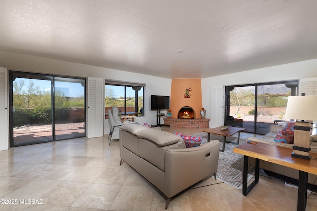 living room with a fireplace and a textured ceiling