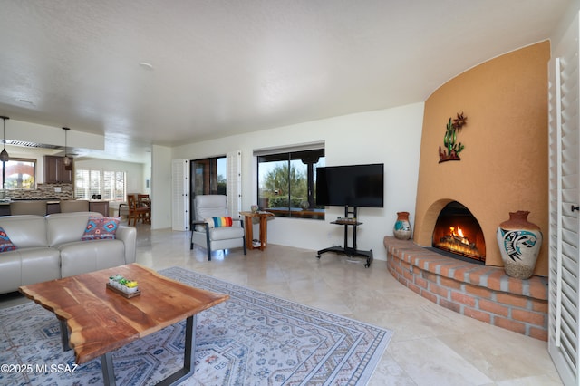 living room with a brick fireplace and plenty of natural light