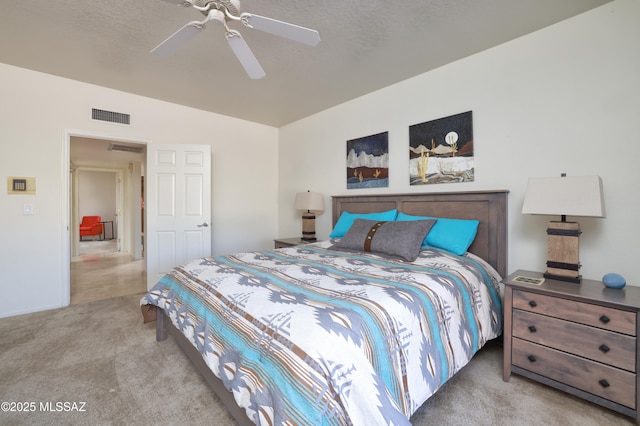 bedroom with lofted ceiling, light carpet, a textured ceiling, and ceiling fan