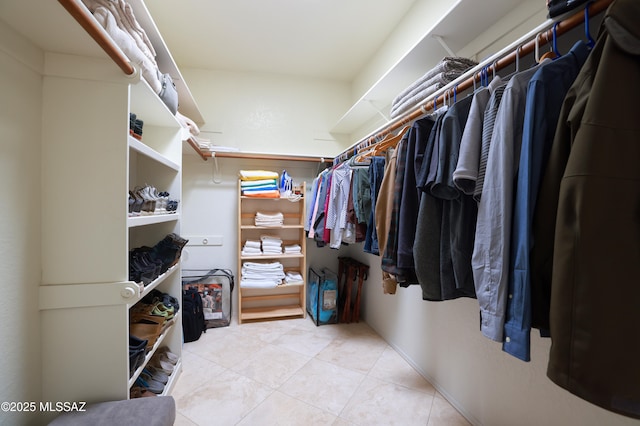 walk in closet featuring light tile patterned flooring