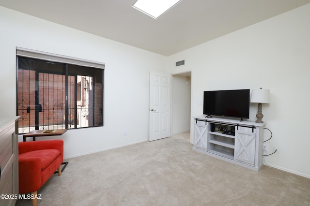 sitting room featuring light colored carpet