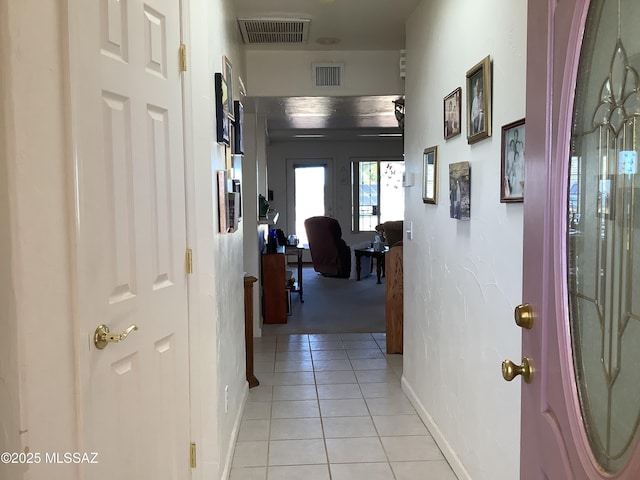 hall featuring light tile patterned flooring