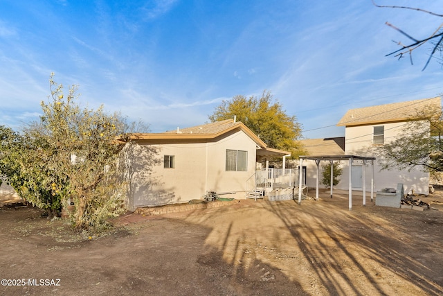 back of property featuring a pergola