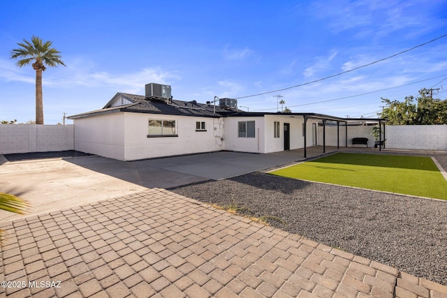 rear view of house with a patio and central AC unit