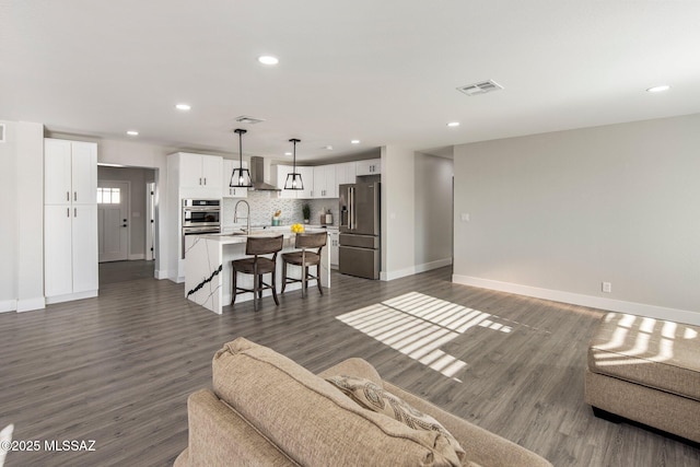 living room featuring dark hardwood / wood-style floors and sink