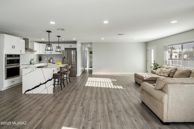 living room featuring dark wood-type flooring