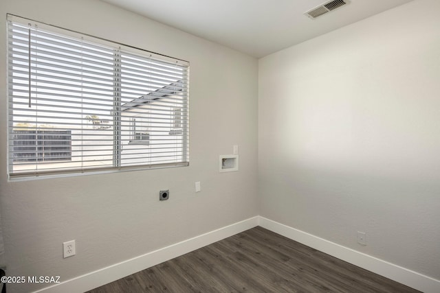 laundry room featuring electric dryer hookup, hookup for a washing machine, and dark hardwood / wood-style flooring