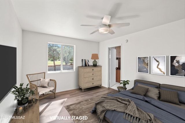 bedroom featuring ceiling fan, baseboards, and wood finished floors