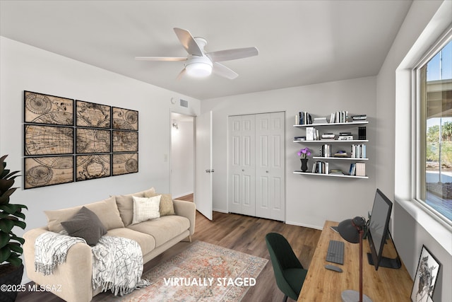 office space with baseboards, ceiling fan, visible vents, and wood finished floors