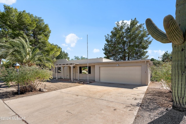 ranch-style home with a garage and concrete driveway