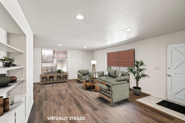 living area with wood finished floors and recessed lighting