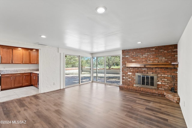 unfurnished living room featuring light wood-type flooring, a fireplace, visible vents, and recessed lighting