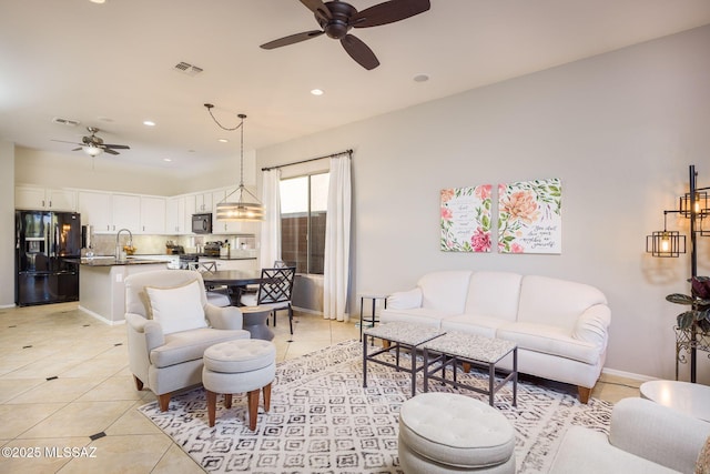 tiled living room with sink and ceiling fan