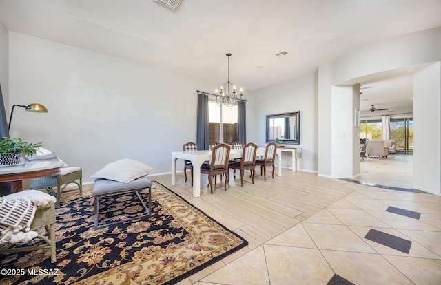 dining area with ceiling fan with notable chandelier and light hardwood / wood-style flooring