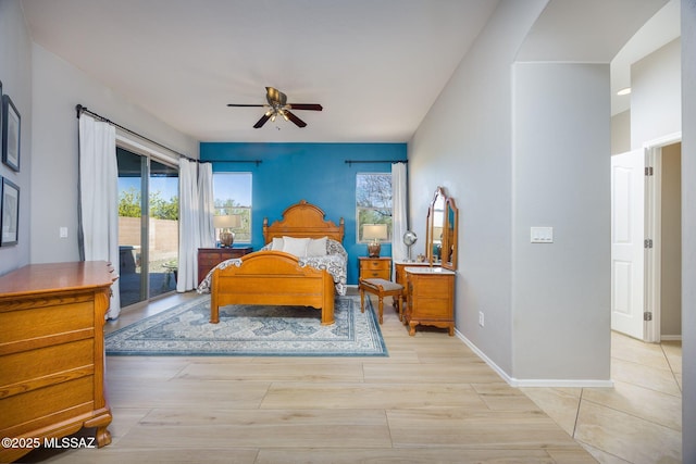 bedroom with light wood-type flooring, access to outside, and ceiling fan