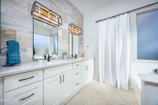 bathroom featuring vanity, tile patterned flooring, and tile walls