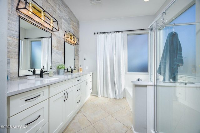 bathroom featuring vanity, plus walk in shower, and tile patterned flooring