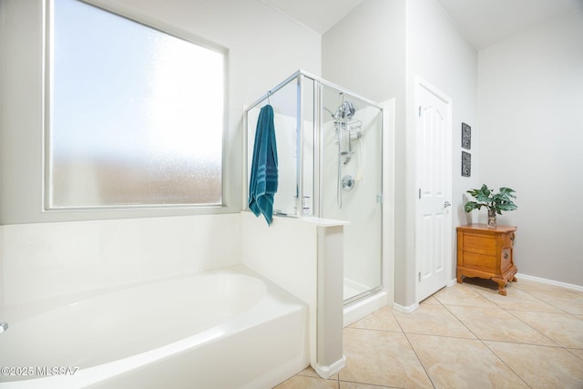 bathroom with separate shower and tub and tile patterned flooring