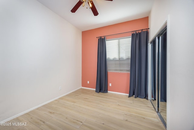 spare room with ceiling fan and light wood-type flooring