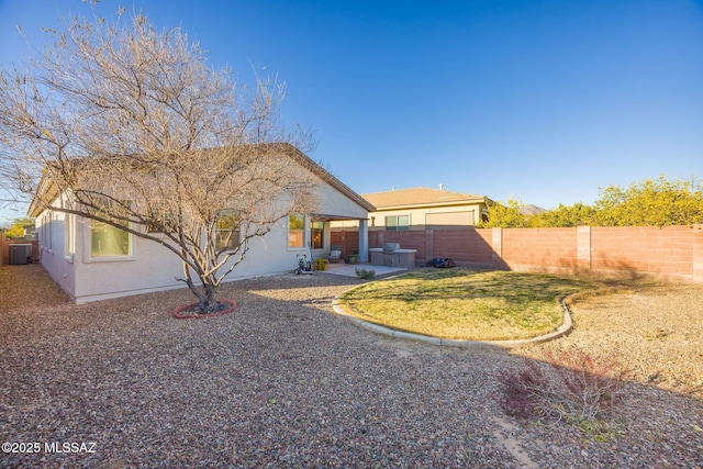 back of house with a lawn, a patio, and central air condition unit