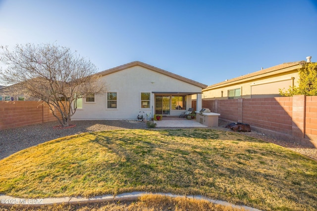 back of property with a patio area and a lawn