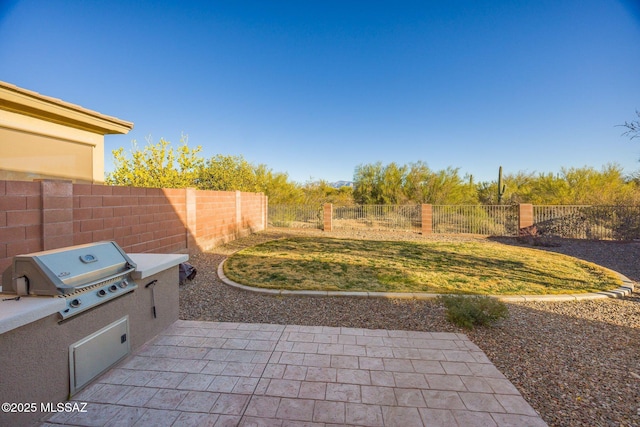 view of patio featuring exterior kitchen and grilling area