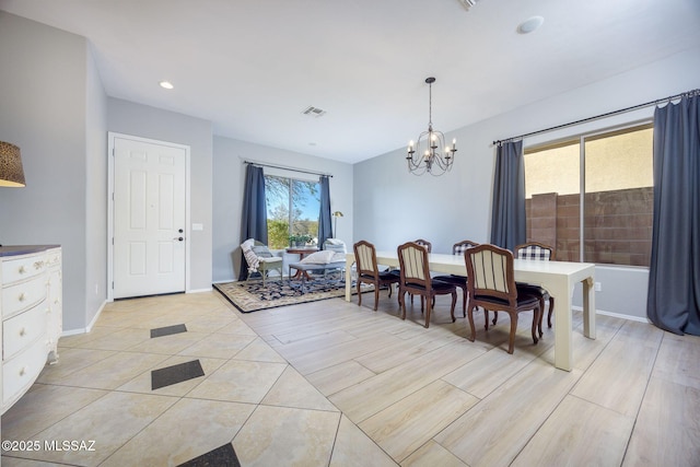 tiled dining space featuring a healthy amount of sunlight and a chandelier