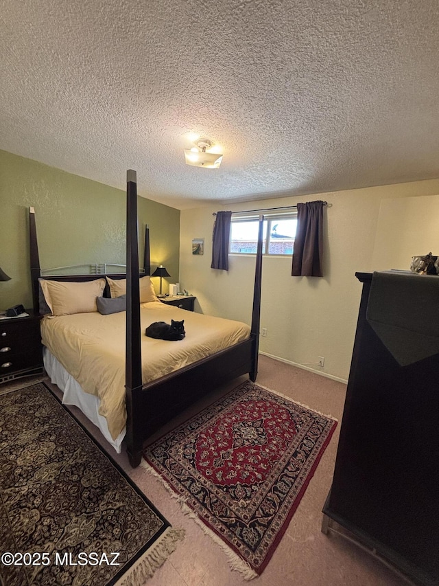 bedroom with carpet floors and a textured ceiling